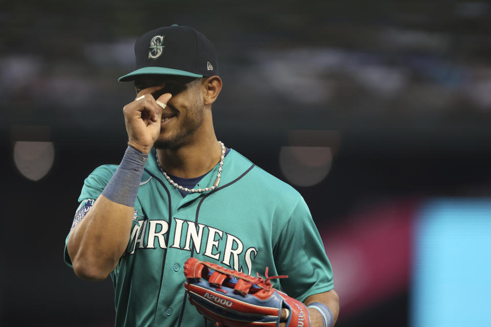 Seattle Mariners center fielder Julio Rodriguez reacts as he enters the dugout during the second inning of a baseball game against the Los Angeles Dodgers, Saturday, Sept. 16, 2023, in Seattle. (AP Photo/Maddy Grassy)