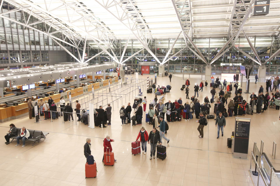 Travelers are on the move or waiting in line in Terminal 1 at Hamburg Airport, Germany, Sunday Nov. 5, 2023. The hostage situation at Hamburg Airport ended Sunday afternoon, after a man drove his vehicle through the gates of the airport with his 4-year-old daughter inside, authorities said. The man was arrested and the girl appears to be unharmed. Flight operations at the airport resumed on Sunday night, almost 24 hours after the hostage situation began. (Bodo Marks/dpa via AP)