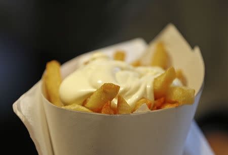 A large cone of fries with mayonnaise sauce is pictured at the Maison Antoine frites stand in Brussels December 4, 2014. REUTERS/Yves Herman