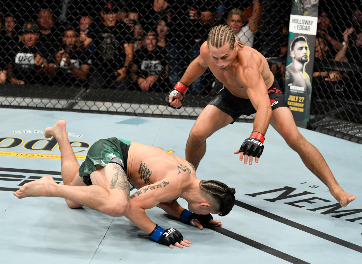 SACRAMENTO, CALIFORNIA - JULY 13:  (R-L) Urijah Faber drops Ricky Simon in their bantamweight bout during the UFC Fight Night event at Golden 1 Center on July 13, 2019 in Sacramento, California. (Photo by Jeff Bottari/Zuffa LLC/Zuffa LLC via Getty Images)