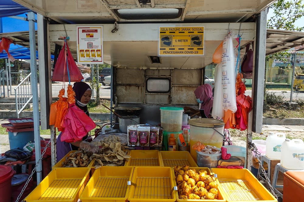 A petty trader sells fried snacks at her stall in Petaling Jaya October 27, 2020. — Picture by Miera Zulyana