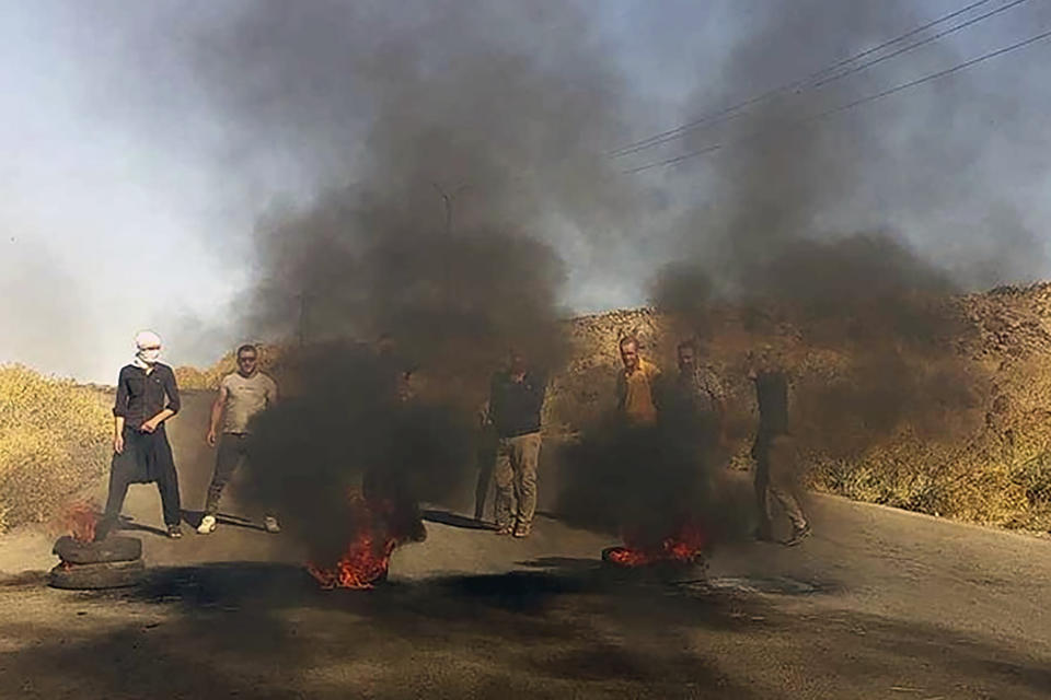 In this photo released by Suwayda24, people stage a protest in the southern city of Sweida, Syria, Tuesday, Aug 22, 2023. Protests spread to new areas of south Syria amid widespread anger over increasing prices, the crash of the Syrian pound, and the dwindling purchase power of most people in the war-torn country, opposition activists said. (Suwayda24 via AP)