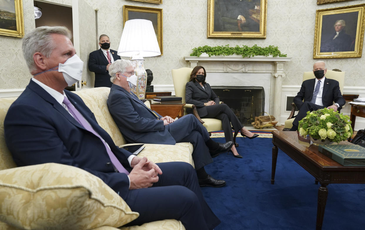 House Minority Leader Kevin McCarthy and Senate Minority Leader Mitch McConnell attend a meeting on infrastructure with U.S. President Joe Biden and Vice President Kamala Harris in the Oval Office of the White House in Washington, U.S., May 12, 2021. REUTERS/Kevin Lamarque