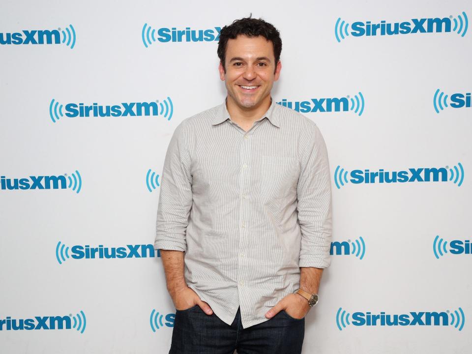 Fred Savage poses against a SiriusXM background