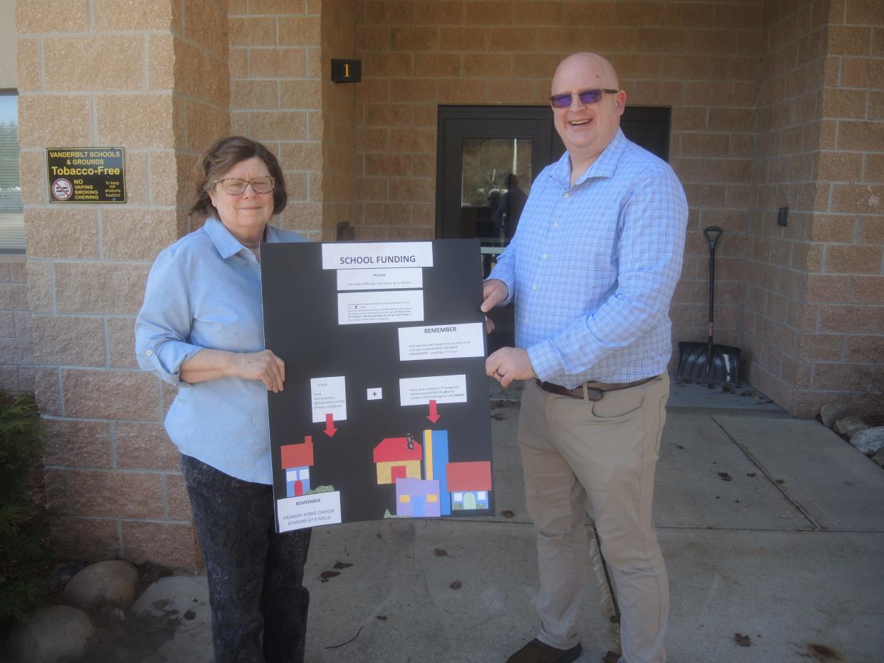 Margaret Schweitzer and David Harwood with a display that explains the millage proposal for the Vanderbilt Area School that will be decided on May 2. Schweitzer is a member of the school board while Harwood is the school's principal.