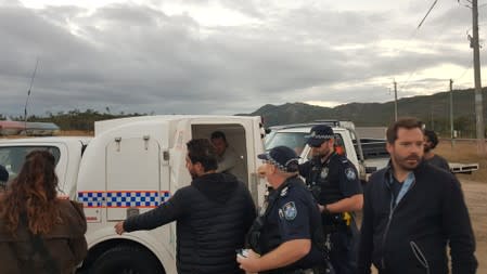 French TV reporter Hugo Clement is seen in a police van after he was arrested while filming protesters blockading the Abbot Point coal port near Bowen