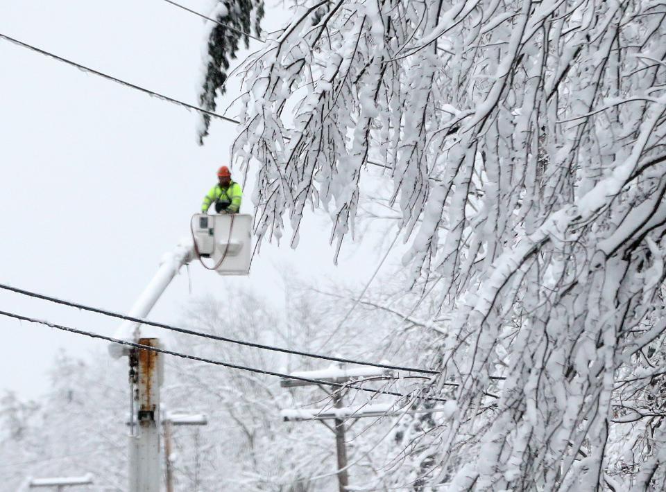 A lineman works on Route 9 in Wells, Maine, as many homes lost power during a winter storm Monday, Jan. 23, 2023.