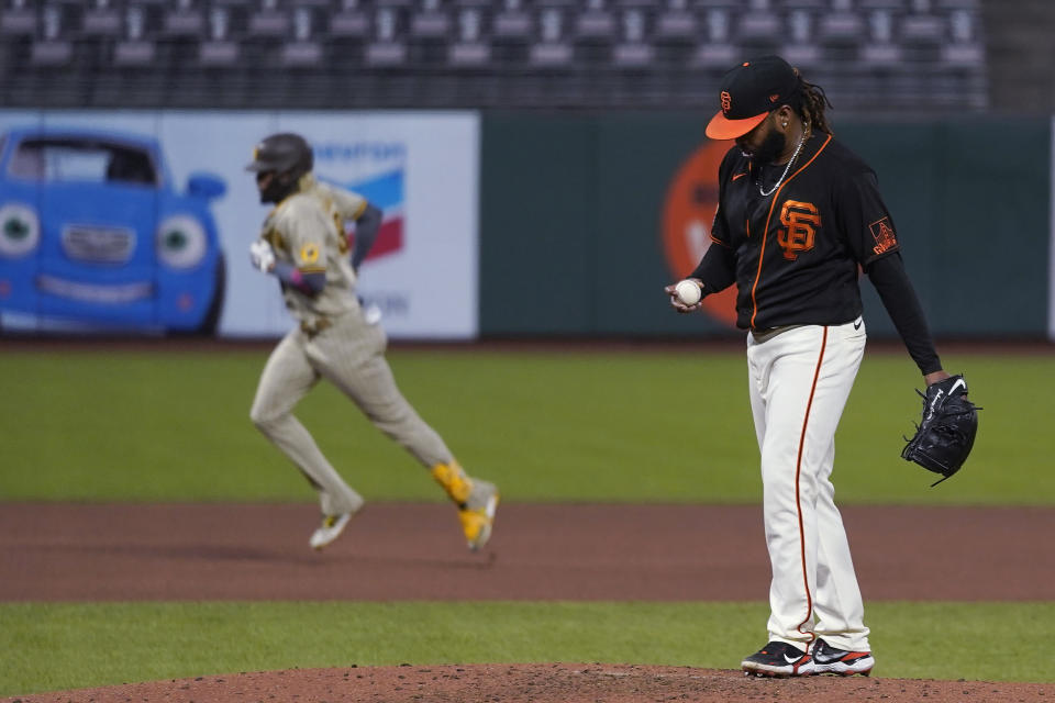 San Diego Padres' Fernando Tatis Jr., left, runs the bases after hitting a solo home run off San Francisco Giants' Johnny Cueto, right, during the fourth inning of a baseball game in San Francisco, Saturday, Sept. 26, 2020. (AP Photo/Eric Risberg)