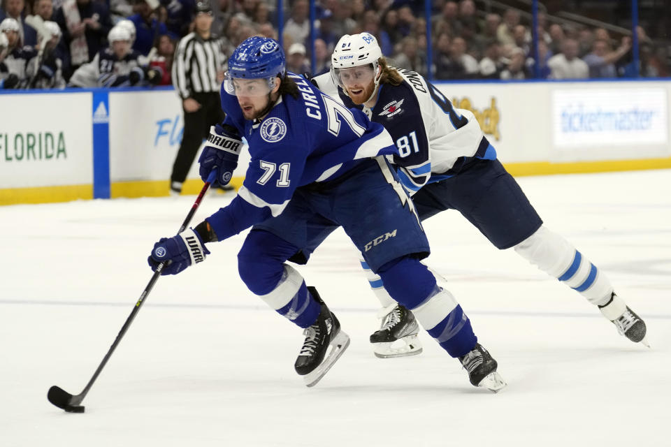 Tampa Bay Lightning center Anthony Cirelli (71) gets around Winnipeg Jets left wing Kyle Connor (81) on his way to a shorthanded goal during the second period of an NHL hockey game Sunday, March 12, 2023, in Tampa, Fla. (AP Photo/Chris O'Meara)
