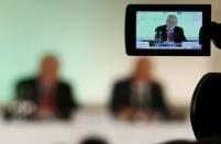 World Anti-Doping Agency's (WADA) former president, Dick Pound, who heads the commission into corruption and doping in athletics, is seen in a TV camera viewfinder as he addresses a news conference in Unterschleissheim near Munich, Germany, January 14, 2016. REUTERS/Michael Dalder