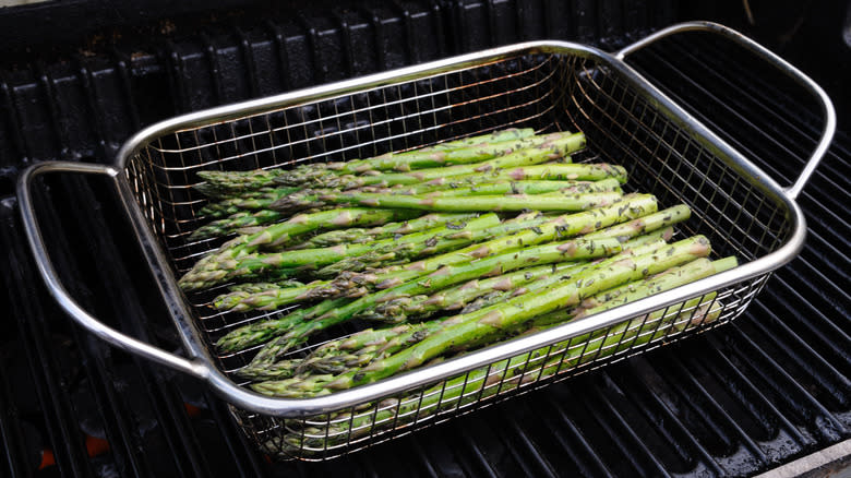 grilling basket filled with asparagus
