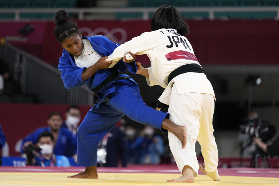 Sarah Leonie Cysique of France, left, and Tsukasa Yoshida of Japan compete during their gold medal match in team judo competition at the 2020 Summer Olympics, Saturday, July 31, 2021, in Tokyo, Japan. (AP Photo/Vincent Thian)