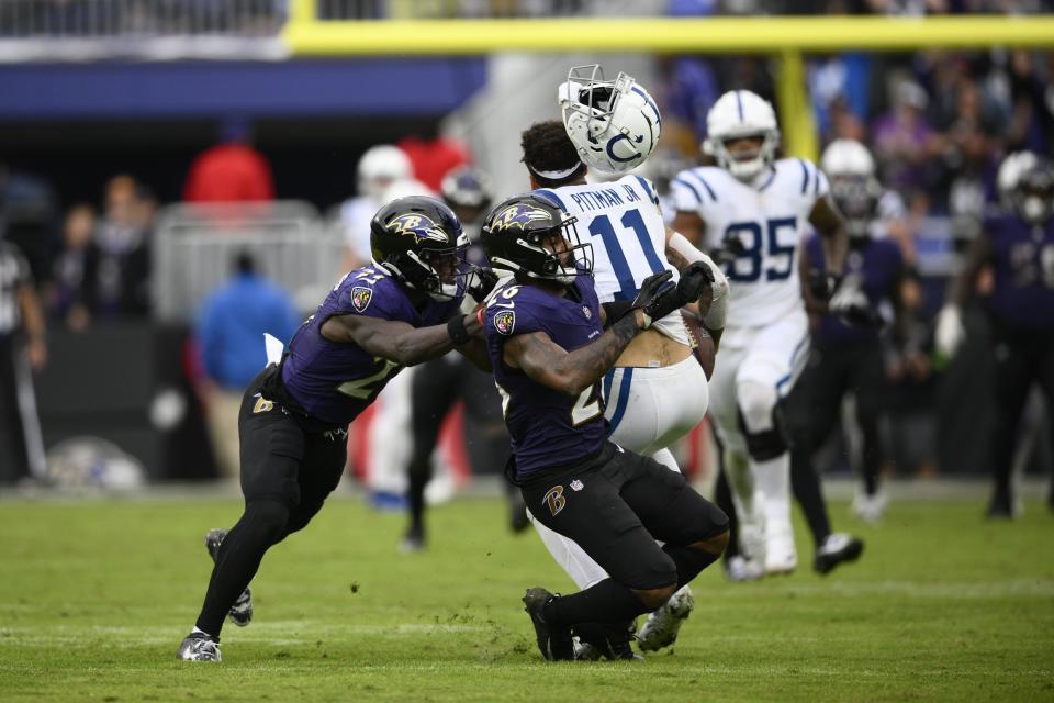 Indianapolis Colts wide receiver Michael Pittman Jr. (11) makes a catch against Baltimore Ravens' Geno Stone (26) during overtime of an NFL football game, Sunday, Sept. 24, 2023, in Baltimore. (AP Photo/Nick Wass)