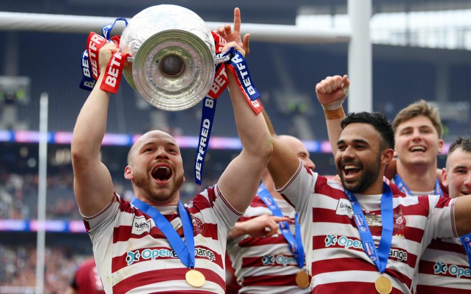 Liam Marshall lifts the famous trophy after Wigan's last-gasp win - GETTY IMAGES