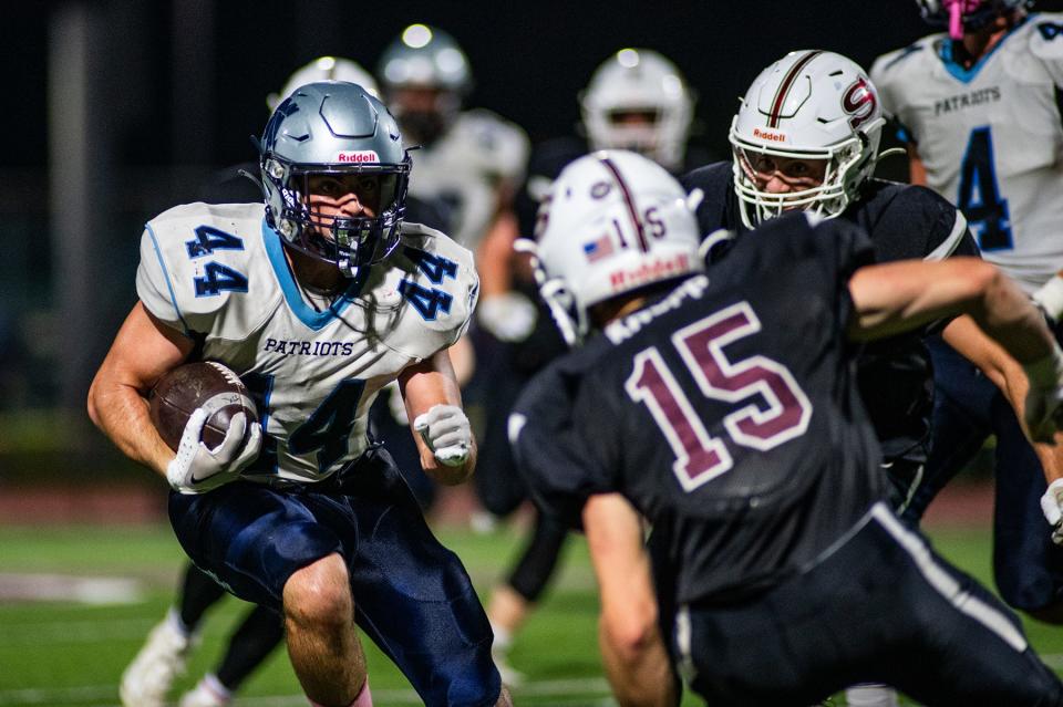 John Jay's Noah Croutch eyes a Scarsdale defender during a Section 1 quarterfinal football game on Oct. 27, 2023.