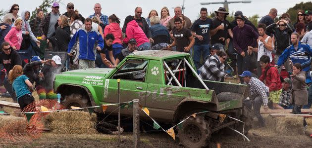 Spectators scramble to free children trapped under the 4WD. Photo: Supplied