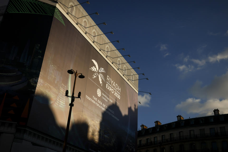 A canvas decorated with a commercial for the Riyadh Expo 2030 protects a building under renovation, Tuesday, Nov. 28, 2023 in Paris. In a high-profile showdown, Rome, Busan and Riyadh are the top contenders to become the host city of the 2030 World Expo, with the organizing body choosing the winner on Tuesday. (AP Photo/Thomas Padilla)