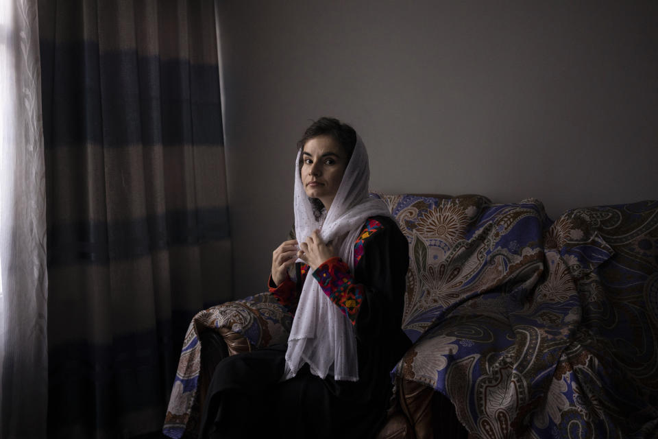 Asita Ferdous sits inside her home in Kabul, Afghanistan on Wednesday, Nov. 10, 2021. She is the director of the Ariana Cinema but is not allowed to enter the cinema as the Taliban ordered female government employees to stay away from their workplaces. (AP Photo/Bram Janssen)