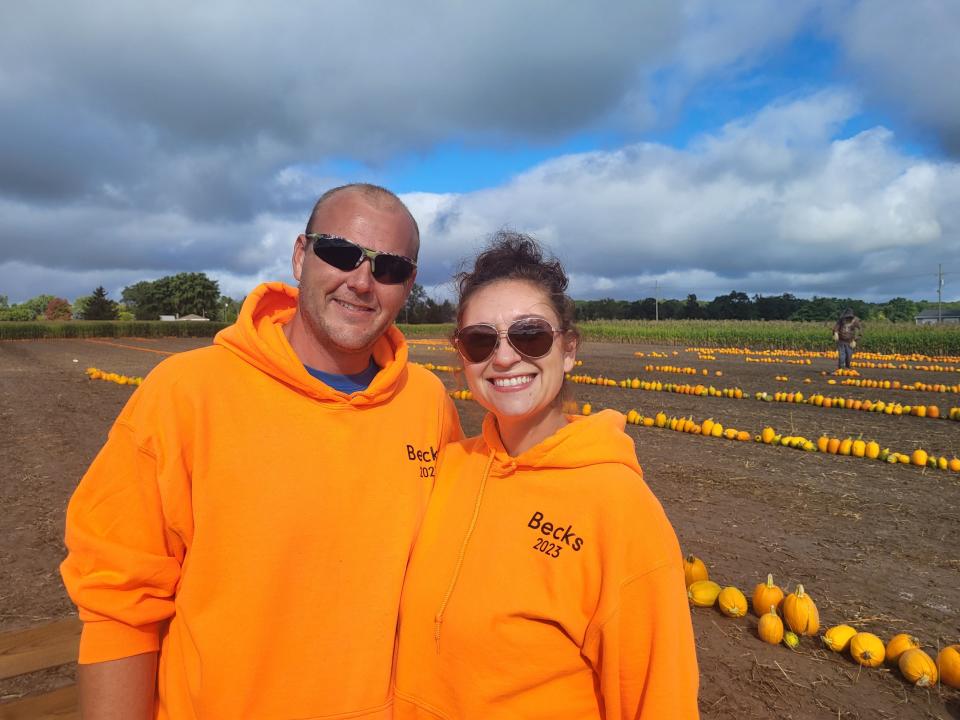 Greg and Kate Beck, owners of Beck's Farm and Produce in Clyde Township, ready to open their pumpkin patch, pictured behind them on Friday, Sept. 8, 2023, and new corn maze this weekend through Oct. 29 at 5021 Beard Road.