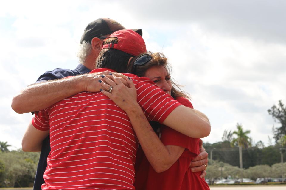 Patty and Glenn Lampp embrace Shane Salas, a friend and co-worker of their slain son Nicolas Lampp, at a memorial service on Thursday, April 6, 2023. The family released balloon's in Nicolas' memory following the conviction of his killer, Joseph Hamilton.