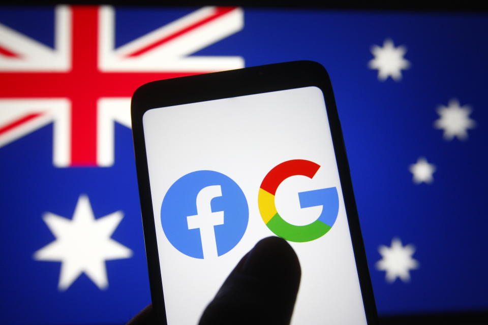 UKRAINE - 2021/02/25: In this photo illustration the Facebook and Google logos are seen on a smartphone in front of the flag of Australia. (Photo Illustration by Pavlo Gonchar/SOPA Images/LightRocket via Getty Images)