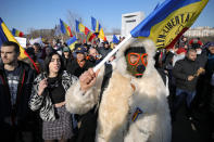 Anti-vaccination protesters rally outside the parliament building in Bucharest, Romania, Sunday, March 7, 2021. Some thousands of anti-vaccination protestors from across Romania converged outside the parliament building protesting against government pandemic control measures as authorities announced new restrictions amid a rise of COVID-19 infections. (AP Photo/Vadim Ghirda)