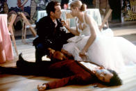 <p>Kristy Swanson slays her prom in an angelic white prom dress with a heart-shaped corset. After she kills the vampire who crashed, she kisses Luke Perry, takes his leather jacket, and leaves the prom to go slay the rest of the vampires. Enough said. (Photo: Everett Collection) </p>
