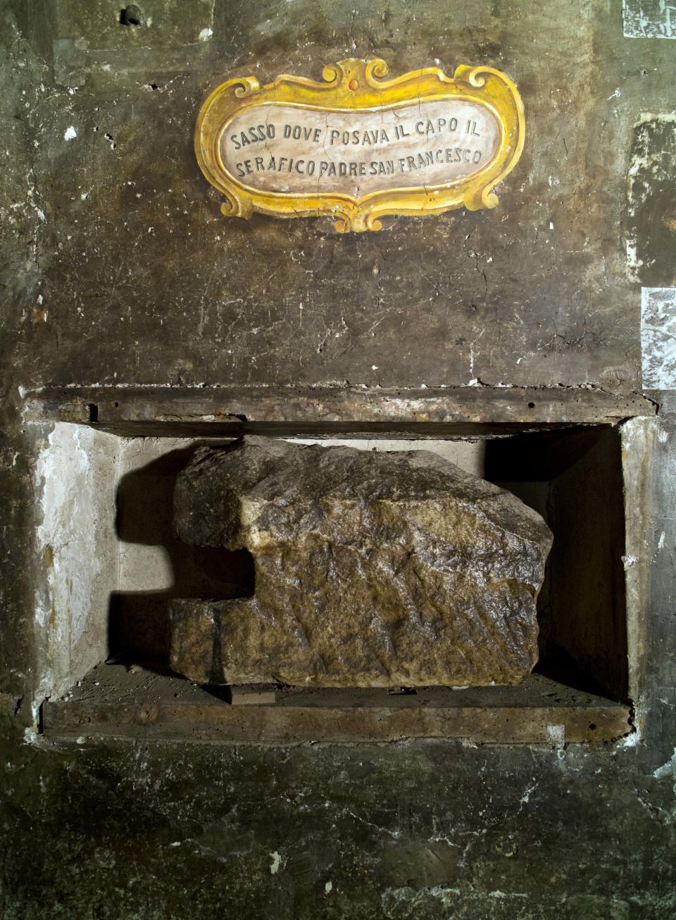 A stone believed to be used by St. Francis of Assisi as a pillow is on display in a cell of the convent of St. Francesco a Ripa in Rome, Friday, Feb. 28, 2014, that he is believed to have visited on the occasion of his trips to the city. The inscription reads in Italian: "Stone where the Serafic Father St. Francis would rest his head". The friars who run the St. Francis a Ripa church in Rome's Trastevere neighborhood are launching a Kickstarter online fundraising campaign Tuesday, March 11, 2014, to try to raise the $125,000 to restore the tiny cell upstairs from the sacristy where St. Francis stayed, The Associated Press has learned. Rather than ask for funding from the Italian government, which owns the church and is responsible for its upkeep, the friars decided on this more democratic crowdfunding initiative thinking it more in keeping with the Franciscan tradition of seeking alms for just what they need, spreading the faith as they beg, and making sure the poor are the priority. (AP Photo/Domenico Stinellis)