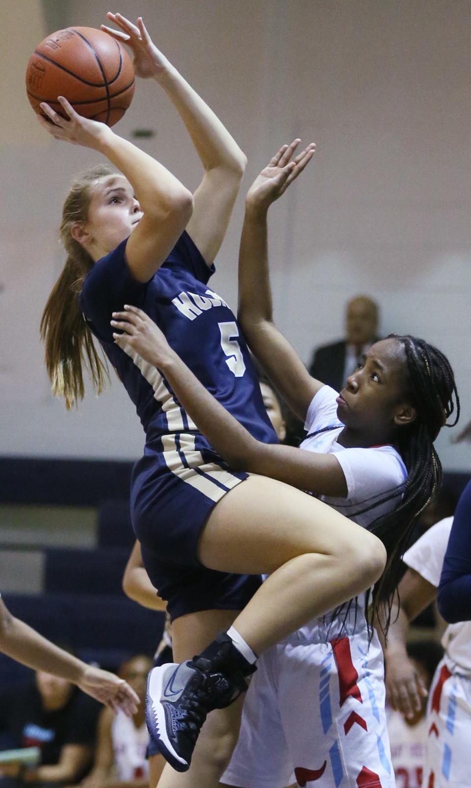 Archbishop Hoban's Rylee Bennett shoots over Villa Angela-St. Joseph's Chineye Obiechina in the first half of the Knights' 77-21 win Monday night in Akron. [Mike Cardew/Beacon Journal]