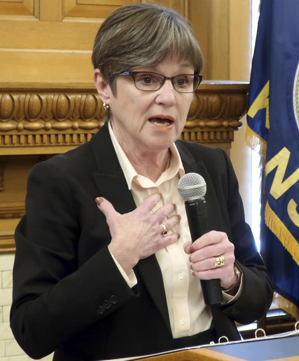 FILE - In this Jan. 24, 2019, file photo, Kansas Gov. Laura Kelly answers questions from reporters during a news conference at the Statehouse in Topeka, Kan. Kelly's fellow Democrats are describing a tax relief plan moving through the Republican-controlled Legislature as a give-away to large corporations, and GOP leaders acknowledge that big businesses would benefit, by design. The state Senate planned to take a final vote Thursday, Feb. 7, 2019, on a bill that is designed to prevent Kansas residents and businesses from paying higher state income taxes because of changes in federal tax laws at the end of 2017. (AP Photo/John Hanna, File)