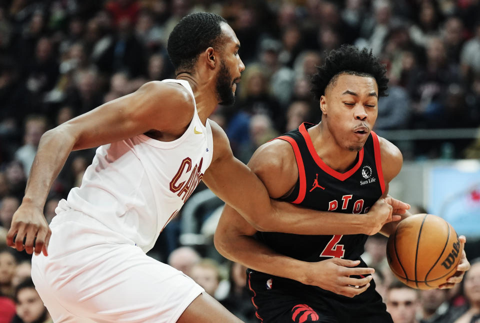 Toronto Raptors forward Scottie Barnes (4) tries to get past Cleveland Cavaliers forward Evan Mobley (4) during the first half of an NBA basketball game, Saturday, Feb. 10, 2024 in Toronto. (Frank Gunn/The Canadian Press via AP)