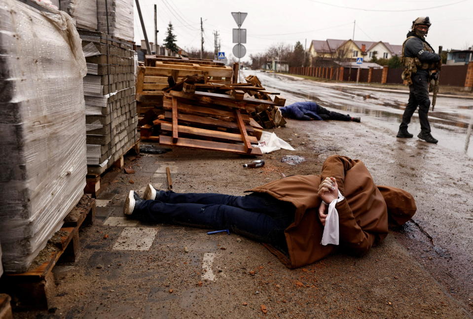 The body of a man with his hands bound behind his back, who according to residents was shot by Russian soldiers, lies in the street amid Russia's invasion of Ukraine, in Bucha, Ukraine, April 3, 2022. / Credit: ZOHRA BENSEMRA/REUTERS