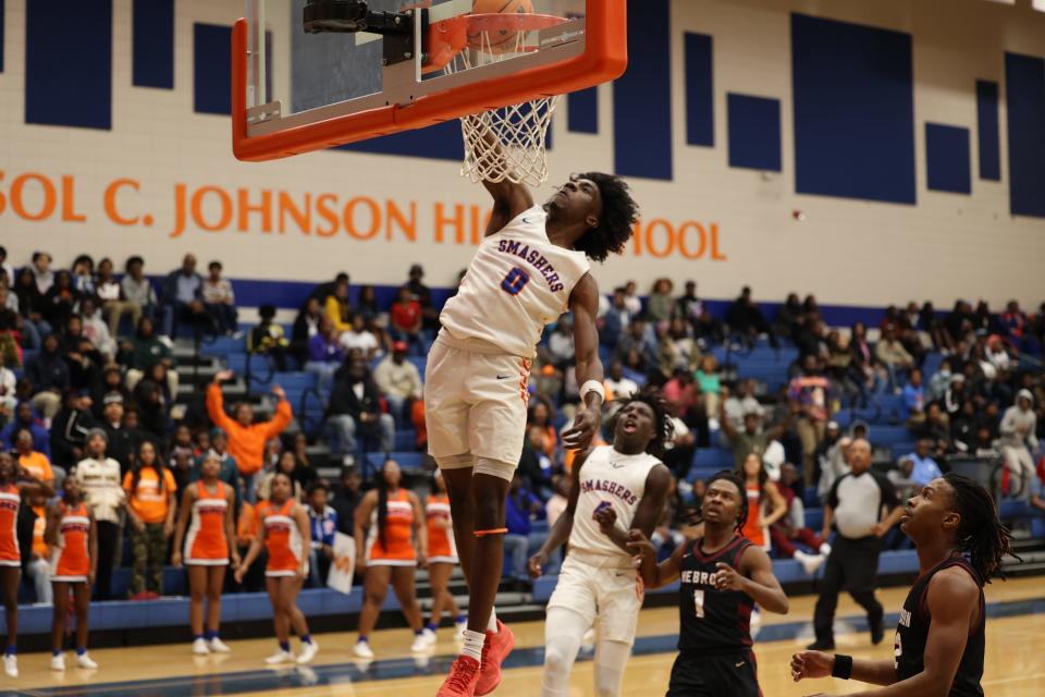 Johnson High's Joshua Quarterman flies in for a basket during the State quarterfinals against Hebron Christian on Wednesday, February 28, 2024.