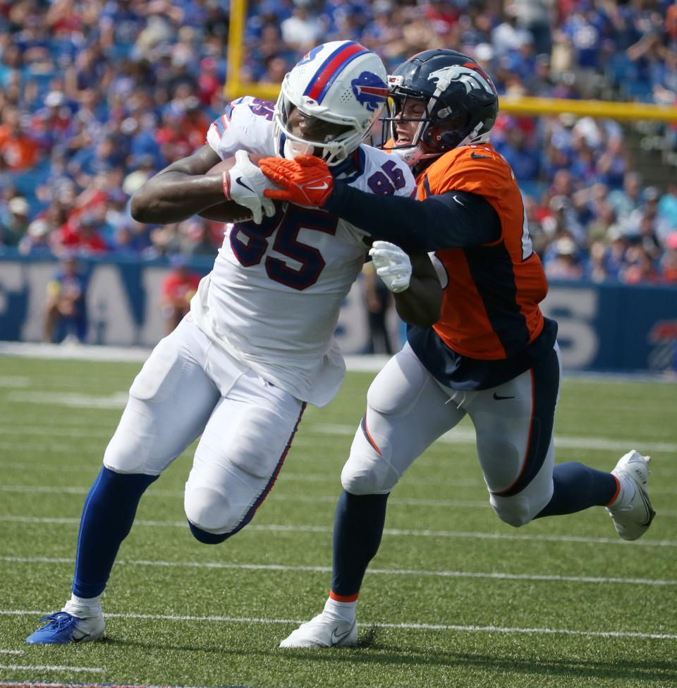 Bills tight end Quintin Morris (85) rumbles for yards after the catch after being pulled down by Denver's Josey Powell  during the Bills preseason game against Denver Saturday, Aug. 20, 2022 at Highmark Stadium.  Buffalo won the game 42-15.