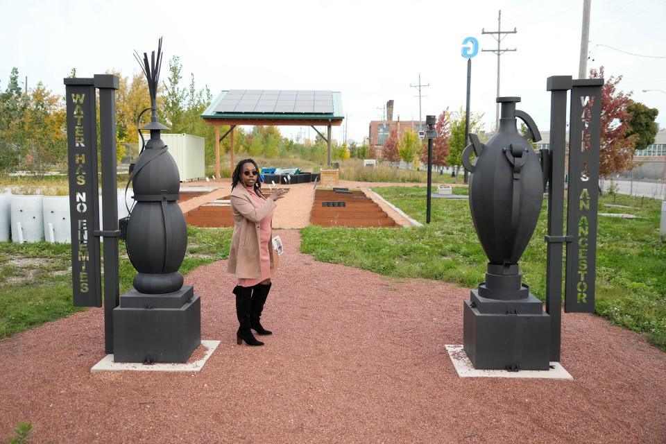 Danitra Jones, the economic development coordinator with Northwest Side Community Development Corporation, explains the artwork aspects, including the African water vessels, by Milwaukee artist Glenn Williams, at Green Tech Station, an open-air classroom, greenspace and a green infrastructure demonstration site at 4101 N. 31st St. in Milwaukee on Wednesday, Oct. 18, 2023. The site provides opportunities to learn about the environment while redirecting stormwater runoff and allows for research and product testing for water-based technologies.