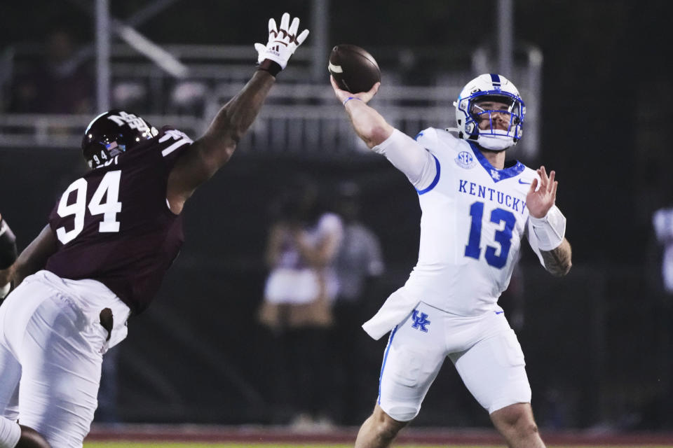 Kentucky quarterback Devin Leary throws a pass under pressure from Mississippi State defensive tackle Jaden Crumedy (94) during the first half of an NCAA college football game in Starkville, Miss., Saturday, Nov. 4, 2023. (AP Photo/Rogelio V. Solis)