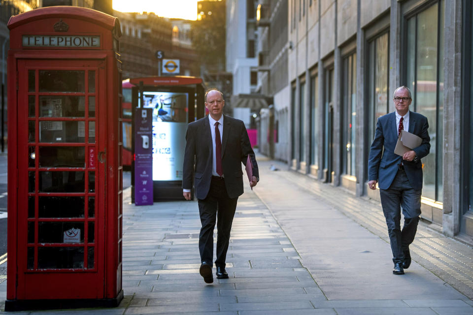 Britain's Chief medical officer Chris Whitty and chief scientific adviser Sir Patrick Vallance walk together on Victoria Street in Westminster, London, as England continues a four week national lockdown to curb the spread of coronavirus, Tuesday, Nov. 24, 2020. Prime Minister Boris Johnson will set out plans to the House of Commons for a strengthened three-tier system of coronavirus restrictions to replace the national lockdown in England and to pave the way for a limited relaxation at Christmas. (Victoria Jones/PA via AP)