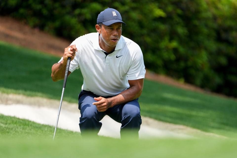 Tiger Woods lines up his putt on the 10th green during the first round of The Masters.