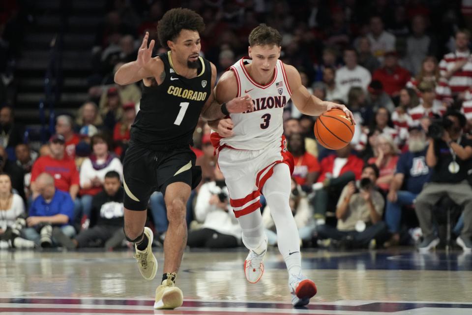 Arizona guard Pelle Larsson shields the ball from Colorado guard J’Vonne Hadley during game, Thursday, Jan. 4, 2024, in Tucson, Ariz. The former Ute scored a team-high 18 points in the Wildcats’ blowout victory over the Buffaloes. | Rick Scuteri, Associated Press