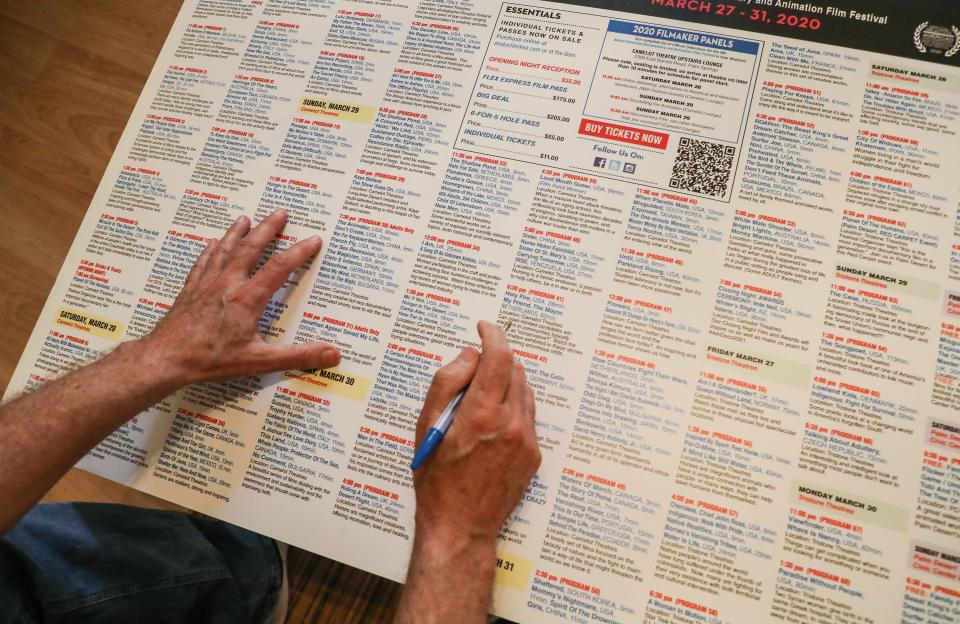 Teddy Grouya looks over 2020 schedule of the The American Documentary and Animation Film Festival at his Palm Springs home, March 31, 2022.