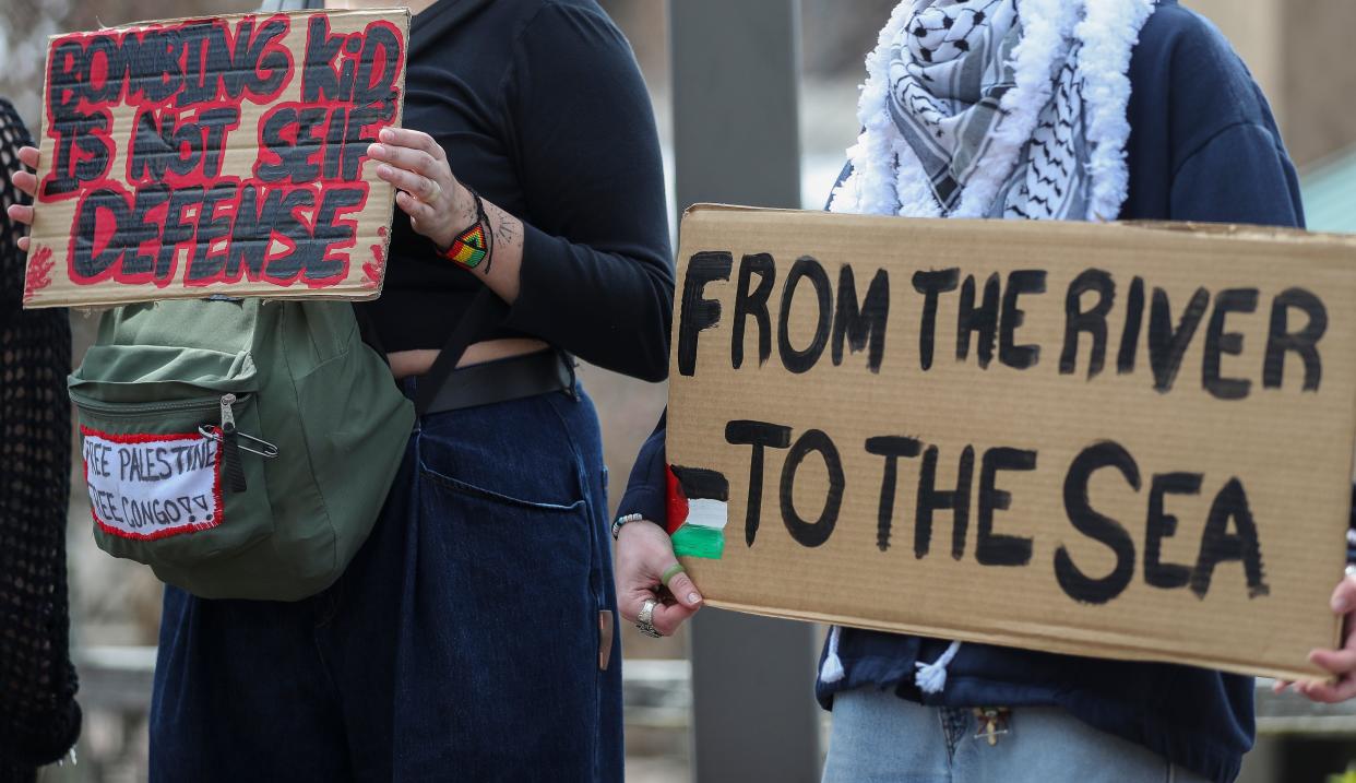 Protesters hold signs are seen during a pro-Palestinian rally on Wednesday, at Phoenix Park on the University of Wisconsin-Green Bay campus. Students came together to call for a ceasefire and acknowledge each of the Palestinian children killed in the Israel-Hamas war in Gaza.