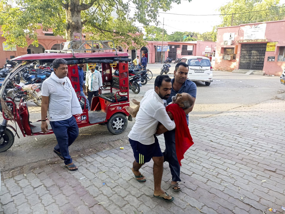 An elderly man is carried to a hospital in Ballia district, in northern Uttar Pradesh state, India, Sunday, June 18, 2023. Swaths of two of India's most populous states are under a grip of sever heat leaving dozens of people dead in several days as authorities issue a warning to residents over 60 and others with ailments to stay indoors during the daytime. (AP Photo)