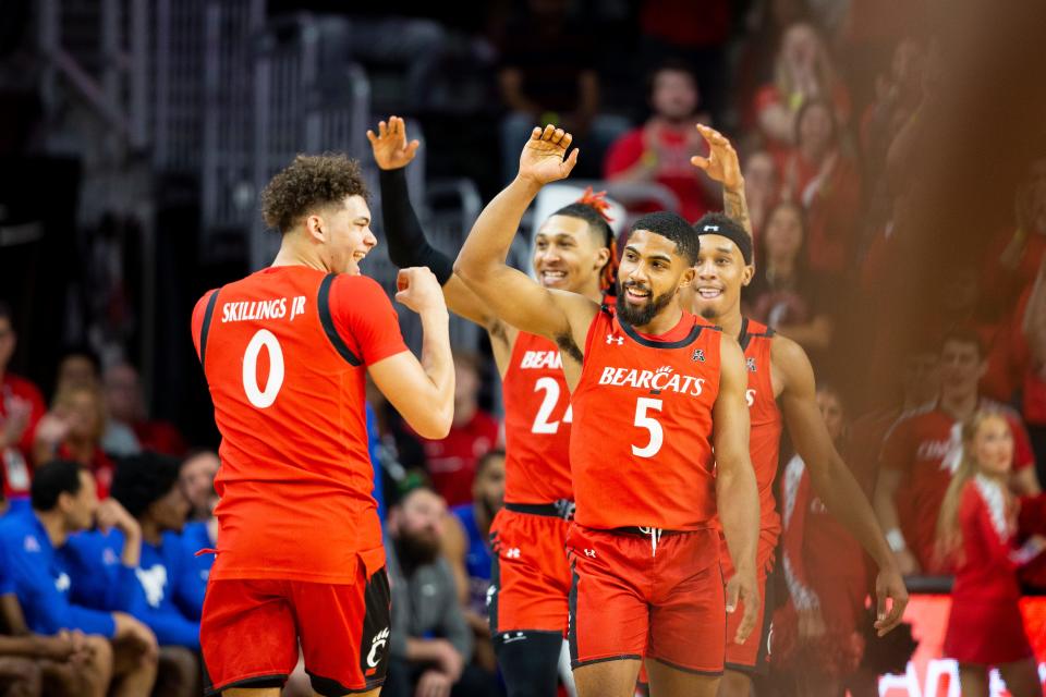 Cincinnati Bearcats guard David DeJulius (5) celebrates after making his last three-point shot during the second half of an NCAA men’s college basketball game on Sunday, March 5, 2023, at Fifth Third Arena in Cincinnati. DeJulius exhausted his eligibility during the final game of the Bearcats’ regular season, defeating the Mustangs 97-74.