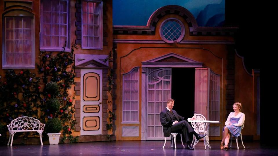 From left, Jeremy Landon Hays as Captain von Trapp and Hayley Podschun as Maria Rainer sit at a table together on Wednesday, July 11, 2023 at the Lexington Opera House in Lexington, Ky. Olivia Anderson/oanderson@herald-leader.com