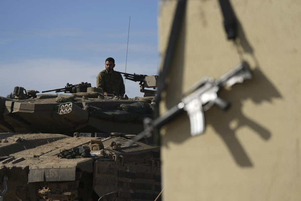 An Israeli soldier stands in his tank at a staging area in southern Israel, near the Gaza border, Thursday, Feb. 1, 2024. (AP Photo/Tsafrir Abayov)