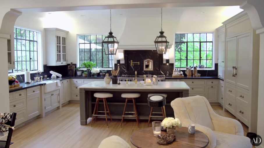 Another shot of their large kitchen, with an island with stools in the middle