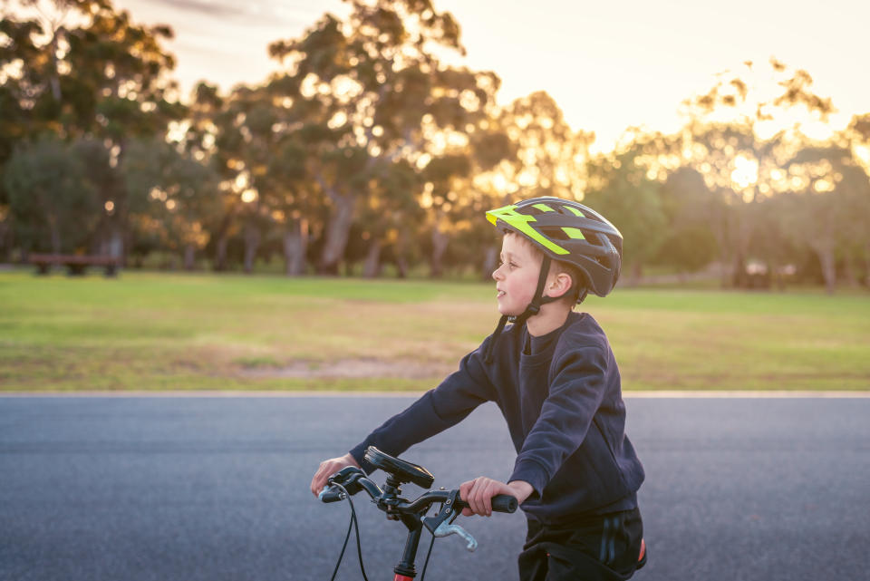 Boy riding his bicycle at sunset. Source: Getty Images