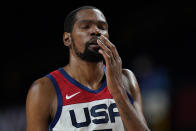 United States's Kevin Durant reacts after he collided with another player and hit his face during a men's basketball preliminary round game against the Czech Republic at the 2020 Summer Olympics, Saturday, July 31, 2021, in Saitama, Japan. (AP Photo/Eric Gay)