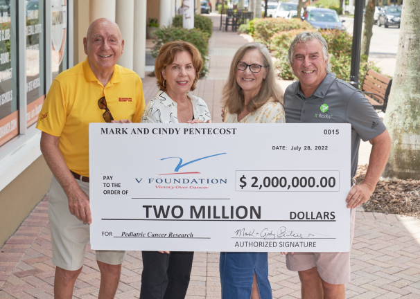 Dick and Lorraine Vitale stand with a $2 million check presented by Cindy and Mark Pentecost, the money to benefit The V Foundation for Pediatric Cancer Research.