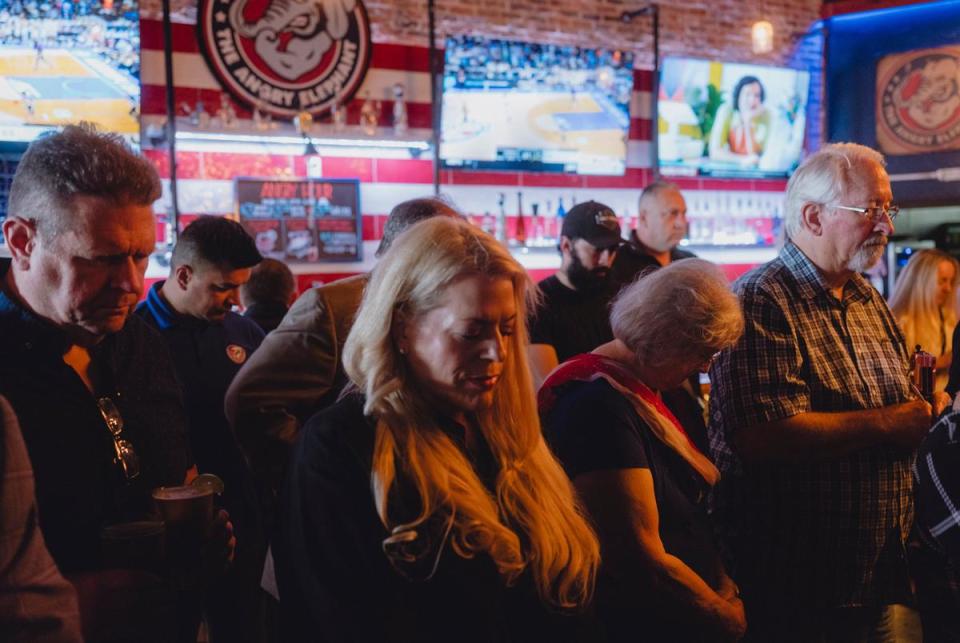 Supporters of Brandon Herrera, Republican candidate for the US House for Texas’ 23rd congressional district, bow their heads in prayer during a campaign event at the Angry Elephant, a politically themed bar, March 14, 2024 in San Antonio.